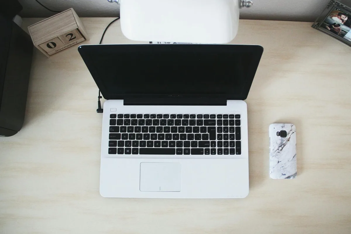 A clean, organized desk with a laptop open, soft natural light, minimal clutter — a workspace for focused content creation