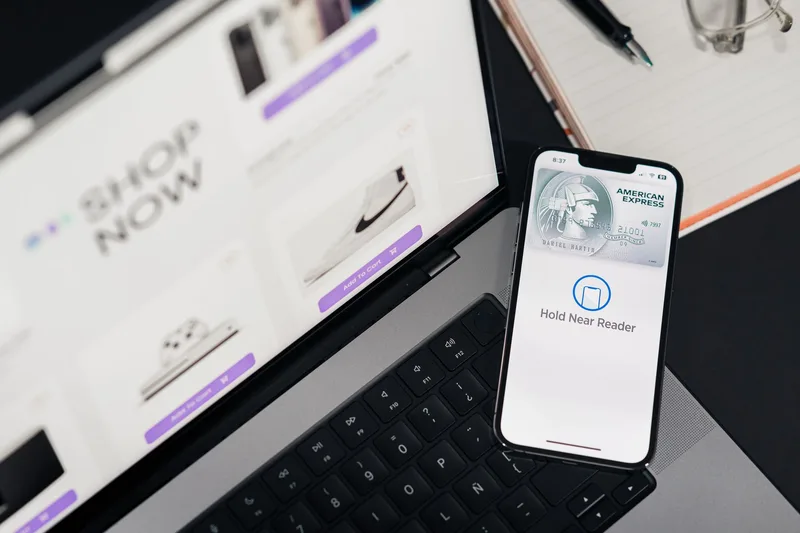 Mobile checkout screen with payment fields shown next to a laptop